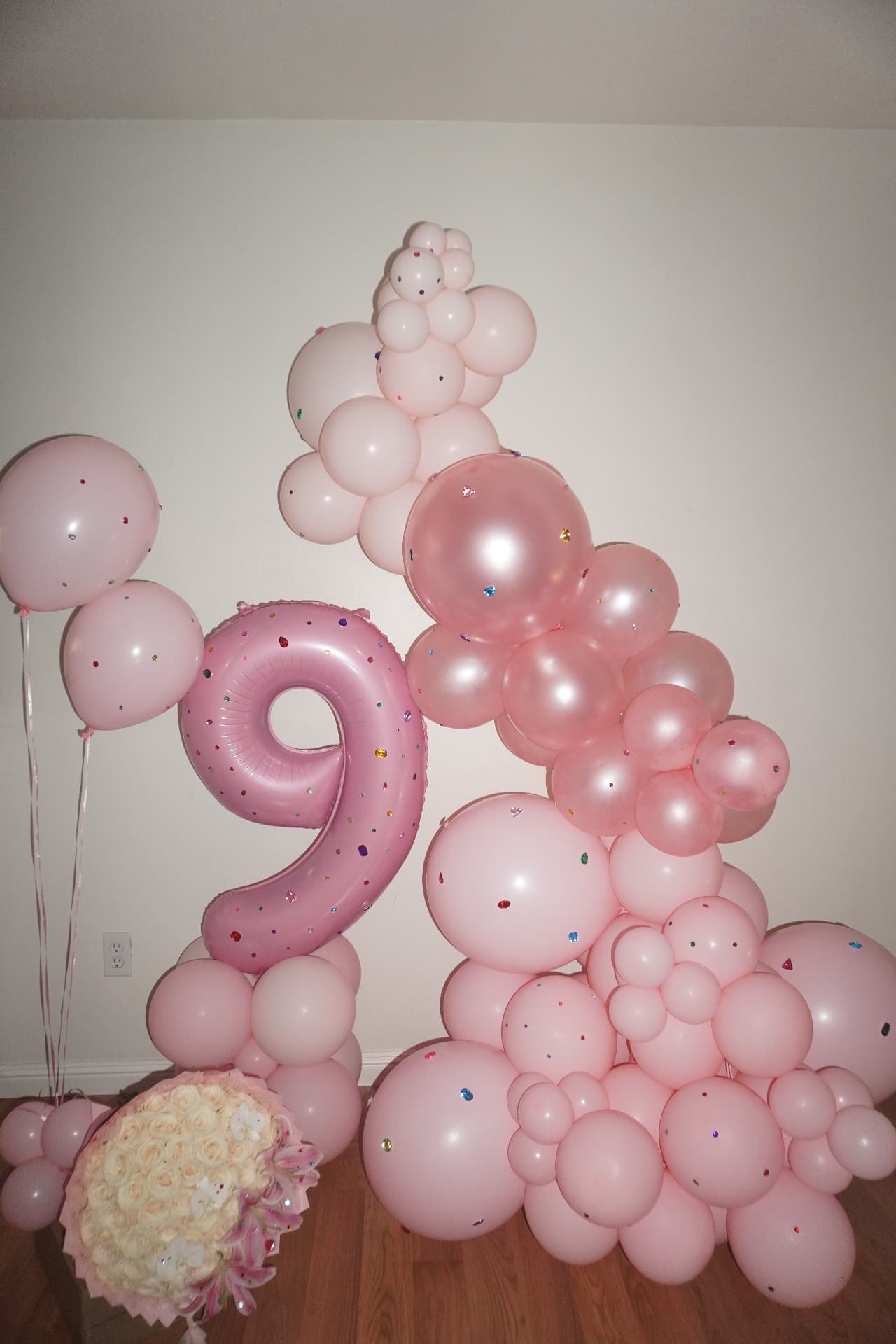 Pink number nine balloon installation with confetti balloons
