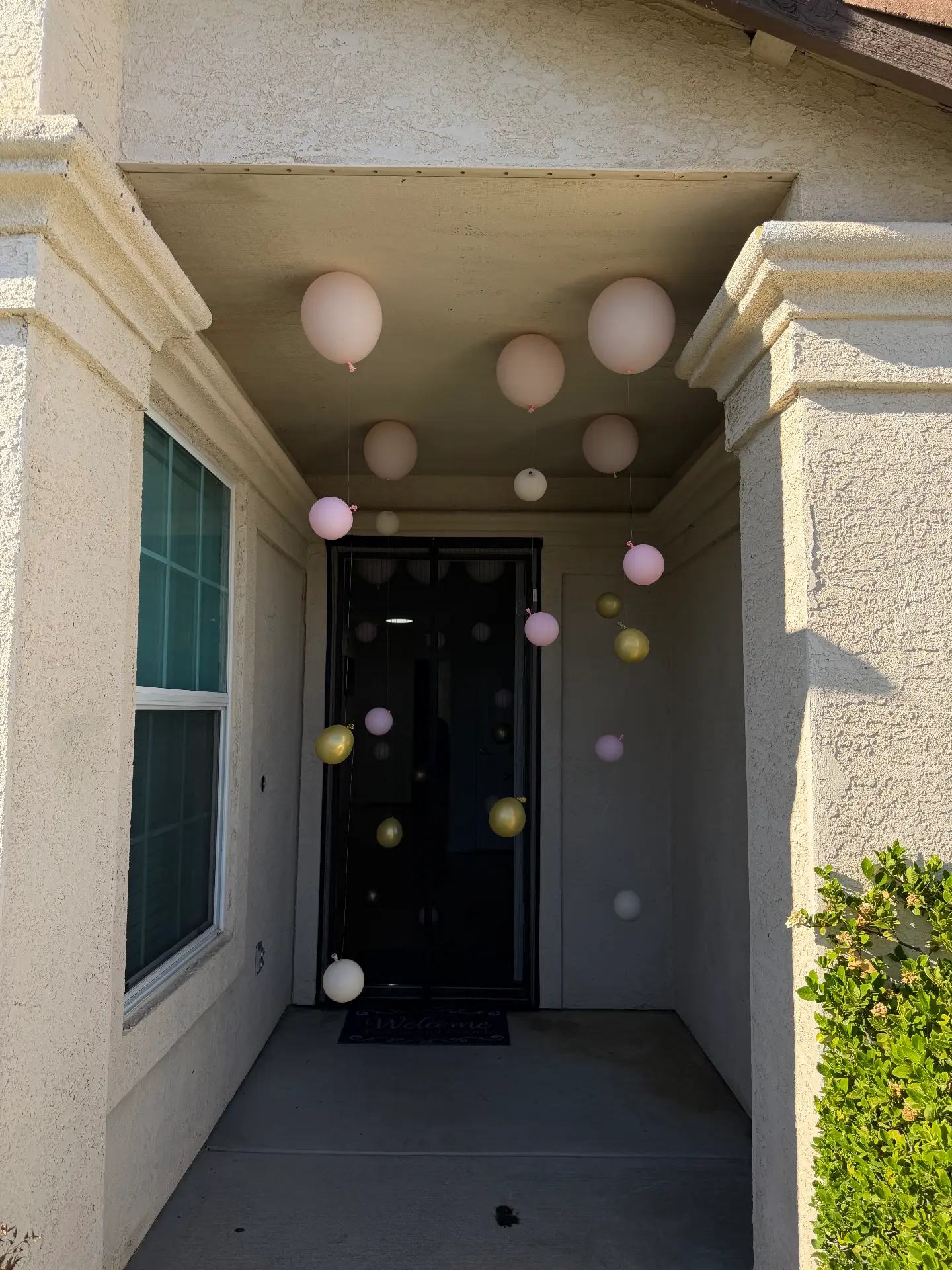 Pink, white and gold floating balloon entrance installation