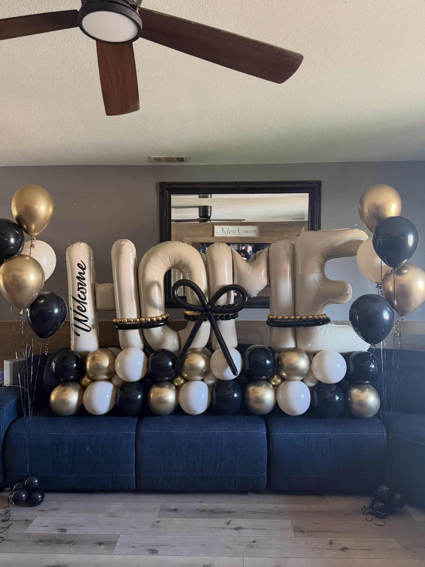 Black, white and gold HOME balloon display for a real estate celebration