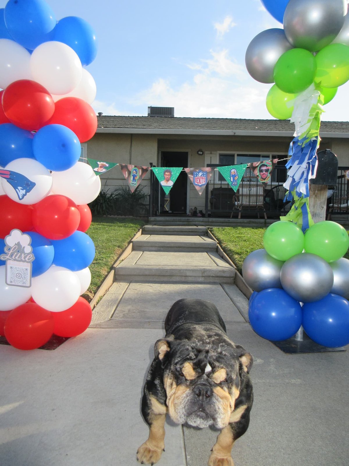 Patriots and Seahawks balloon columns framing a front walkway for a game day party