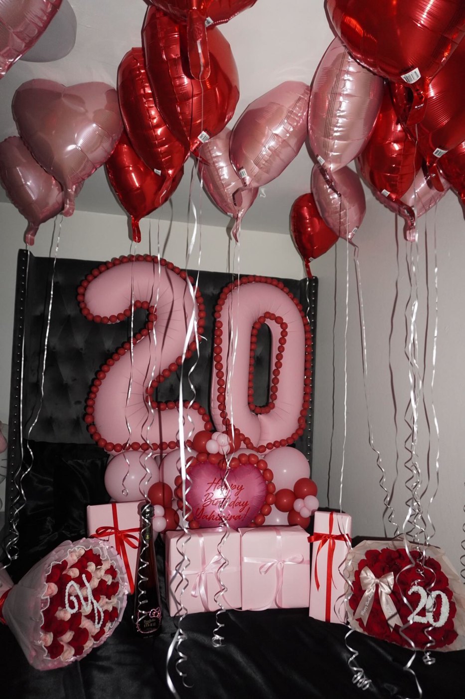 Red and pink 20th birthday balloon numbers with heart balloons