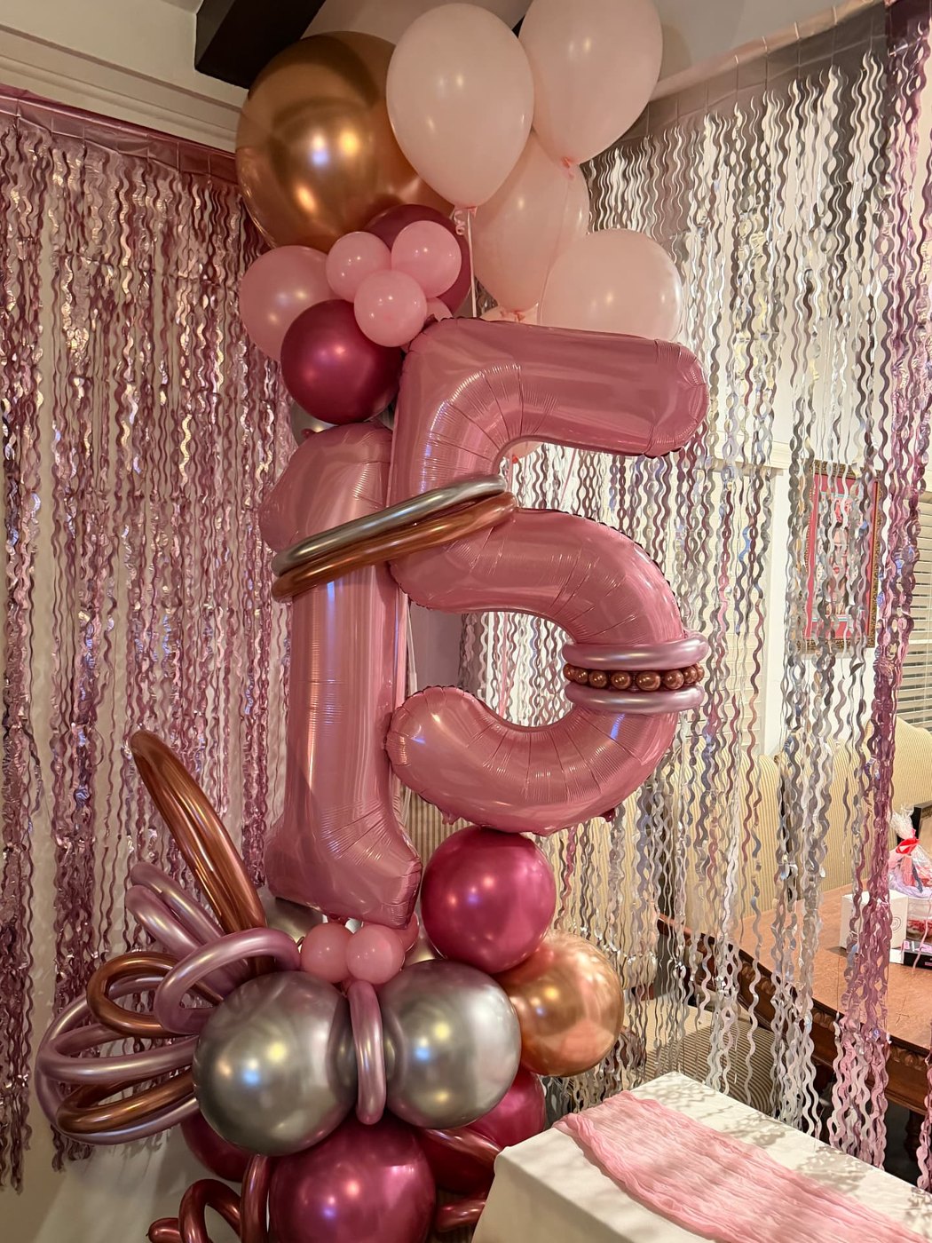 Rose gold number 15 balloon bouquet with fringe backdrop