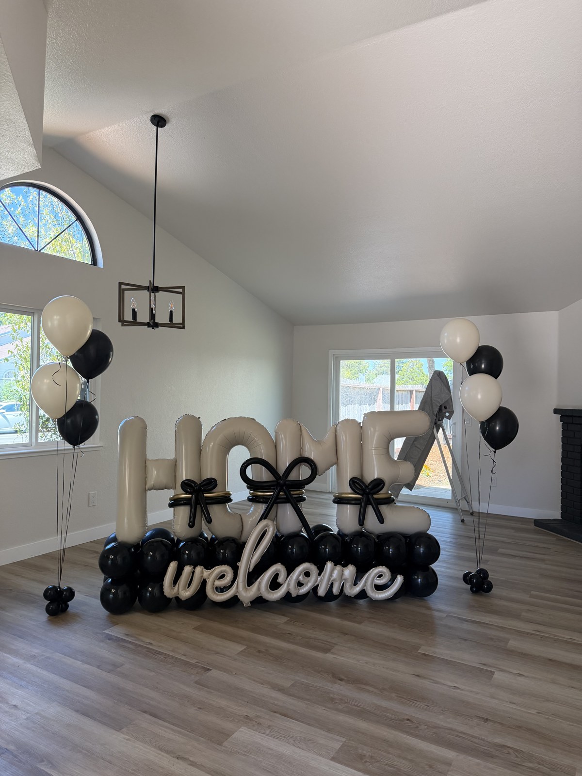 Black and ivory HOME welcome balloon display for a realtor home closing